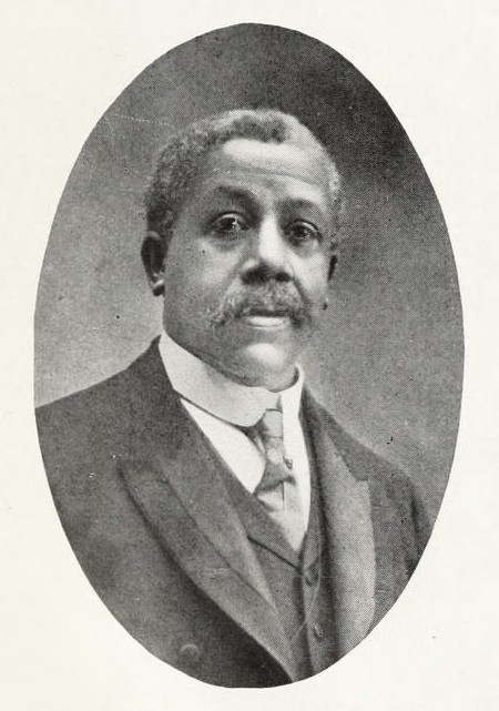 Black and white portrait of Edward Bouchet circa 1912. Bouchet is wearing a dark, three-piece suit.