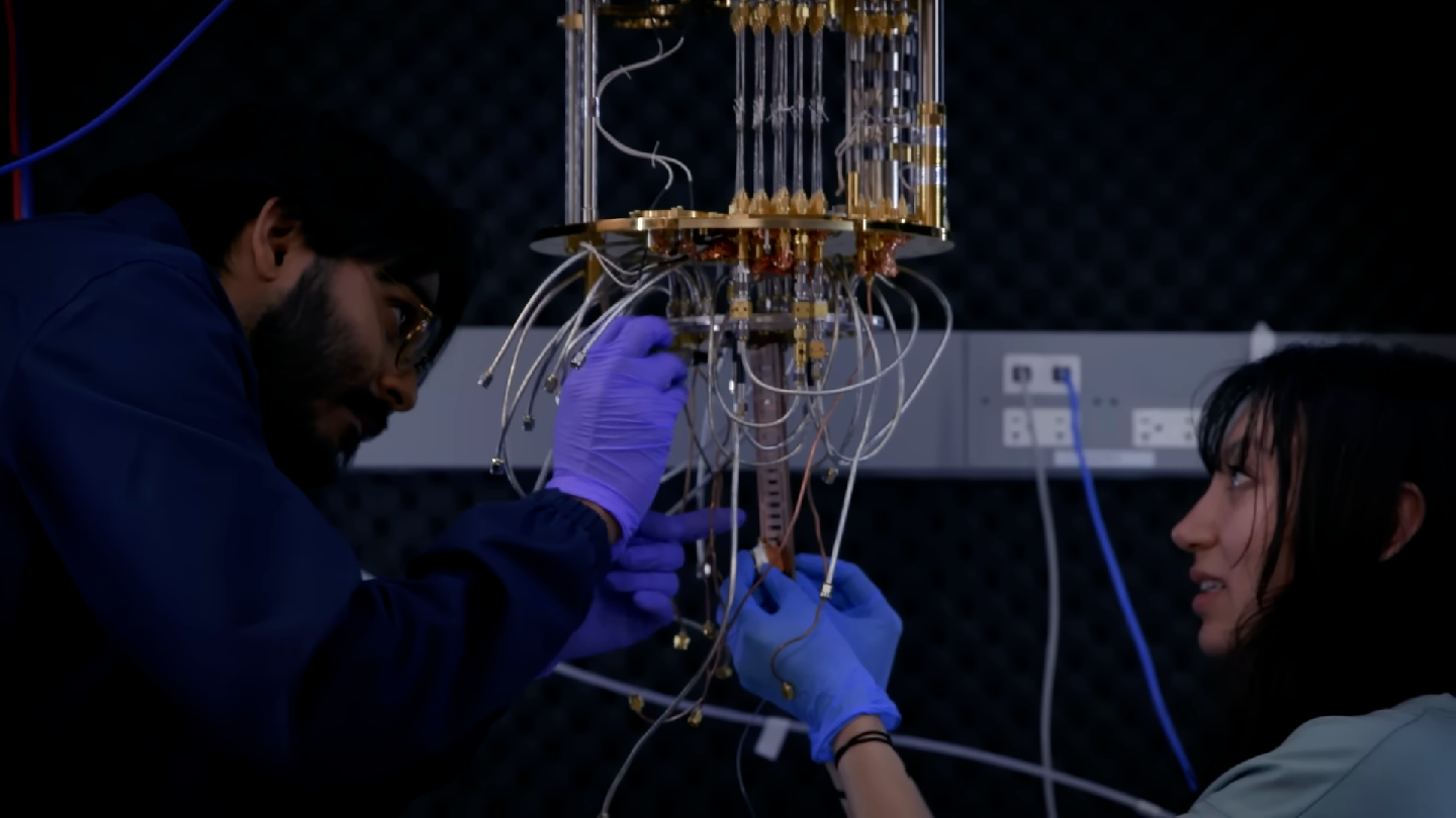 Shanto and a peer work with quantum equipment.