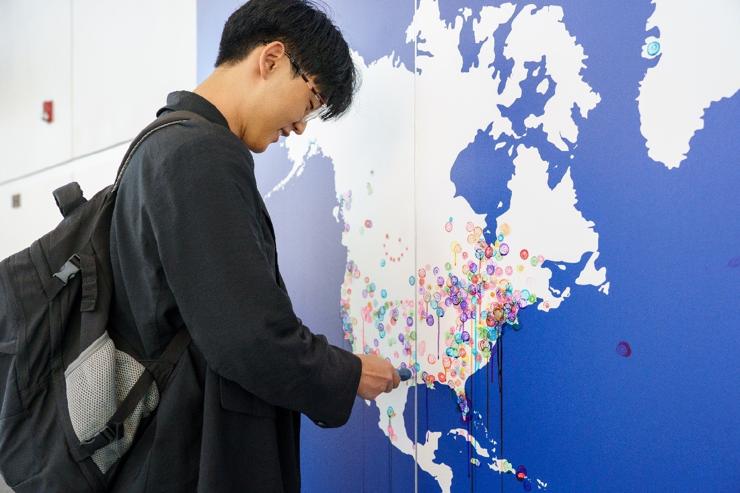 A student marking a location on a map of North America