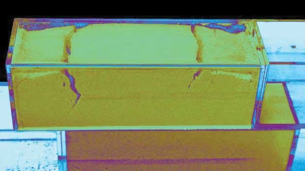 Two rectangular prisms, one on top of the other, the top with two cracks.