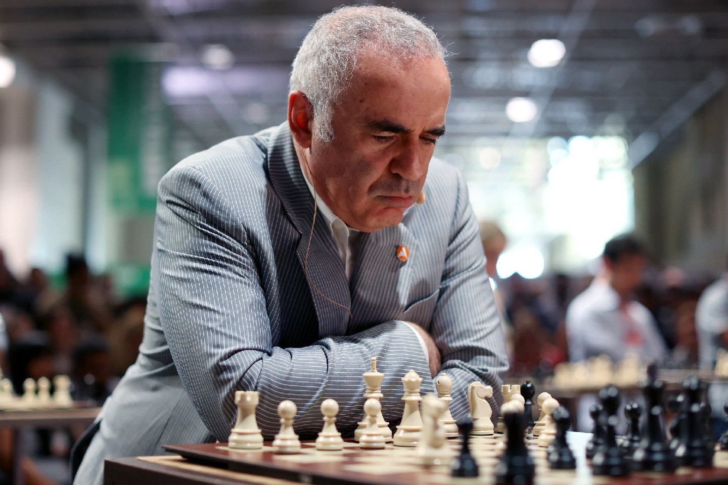 A man seated in front of a chessboard.