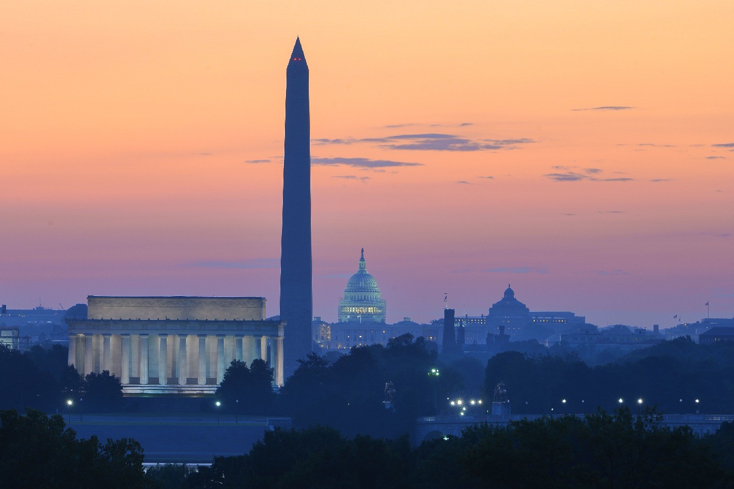 The Washington, D.C., skyline at dusk, with several monuments visible.
