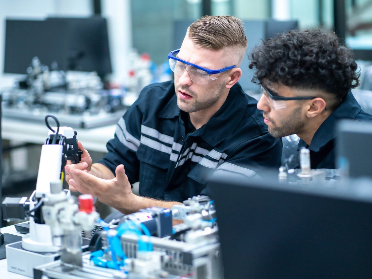 Two physics students perform an experiment in the lab