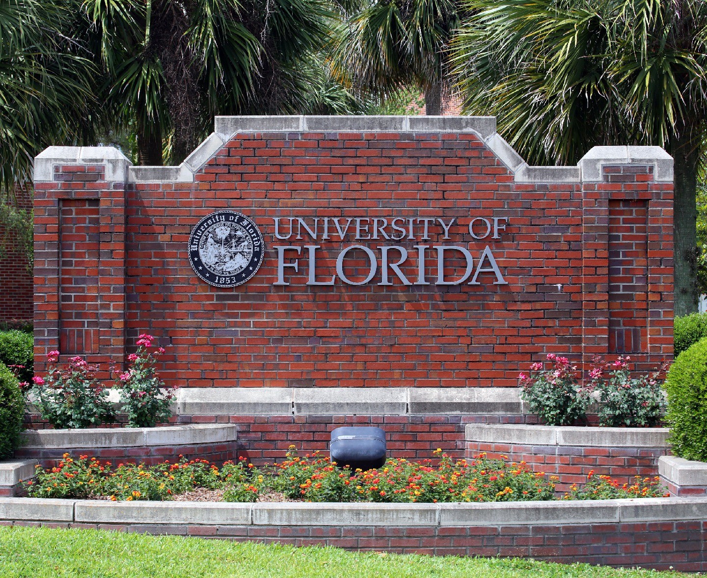 A low brick wall adorned with the University of Florida's name and seal.