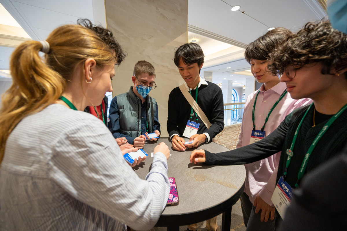 Students standing around a table