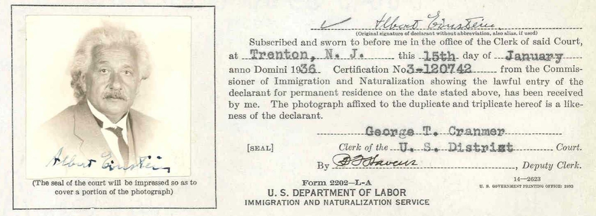  A black-and-white document that includes a portrait photograph of Einstein, alongside official text and signatures from 1936.