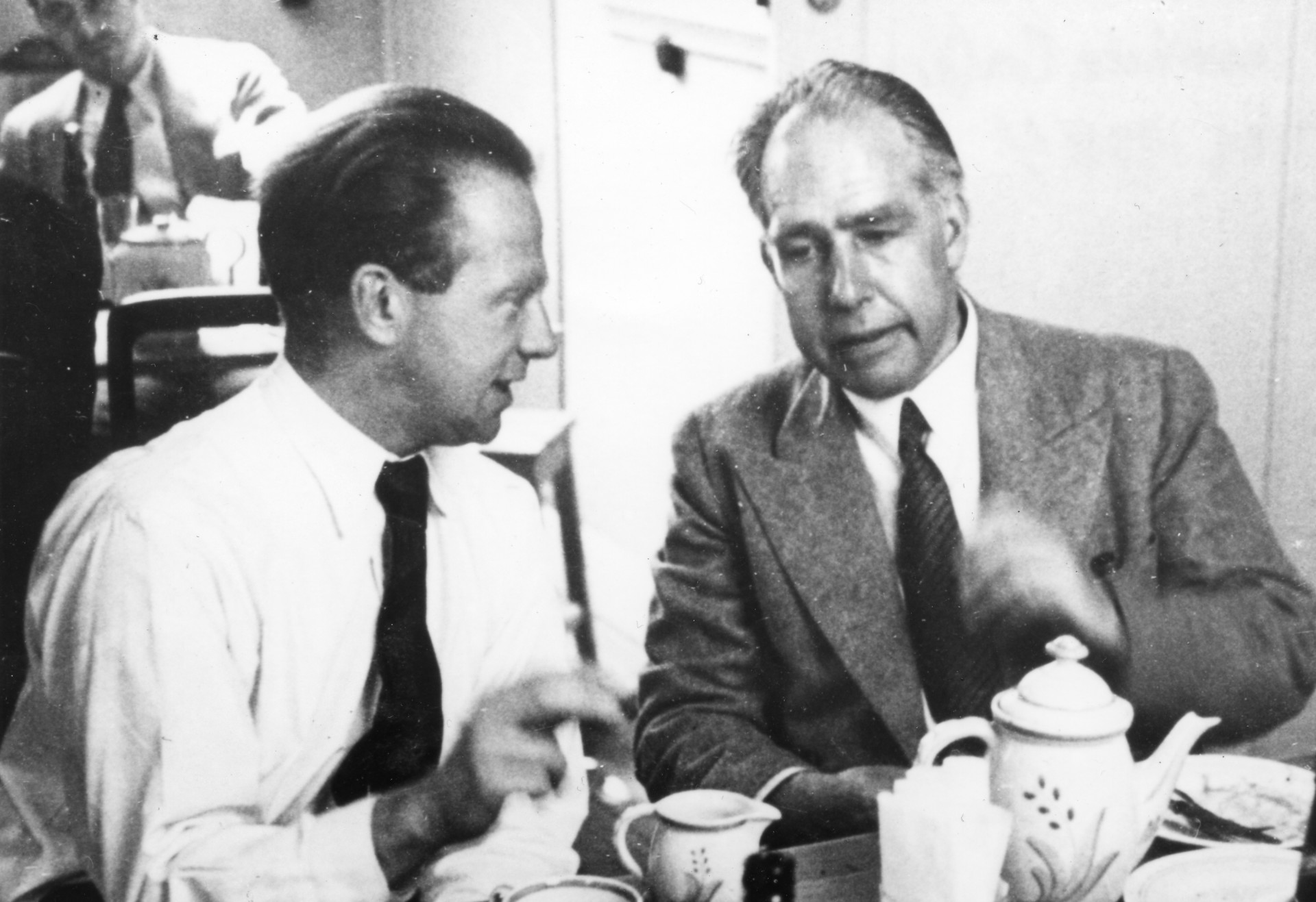 Heisenberg and Bohr converse over breakfast.
