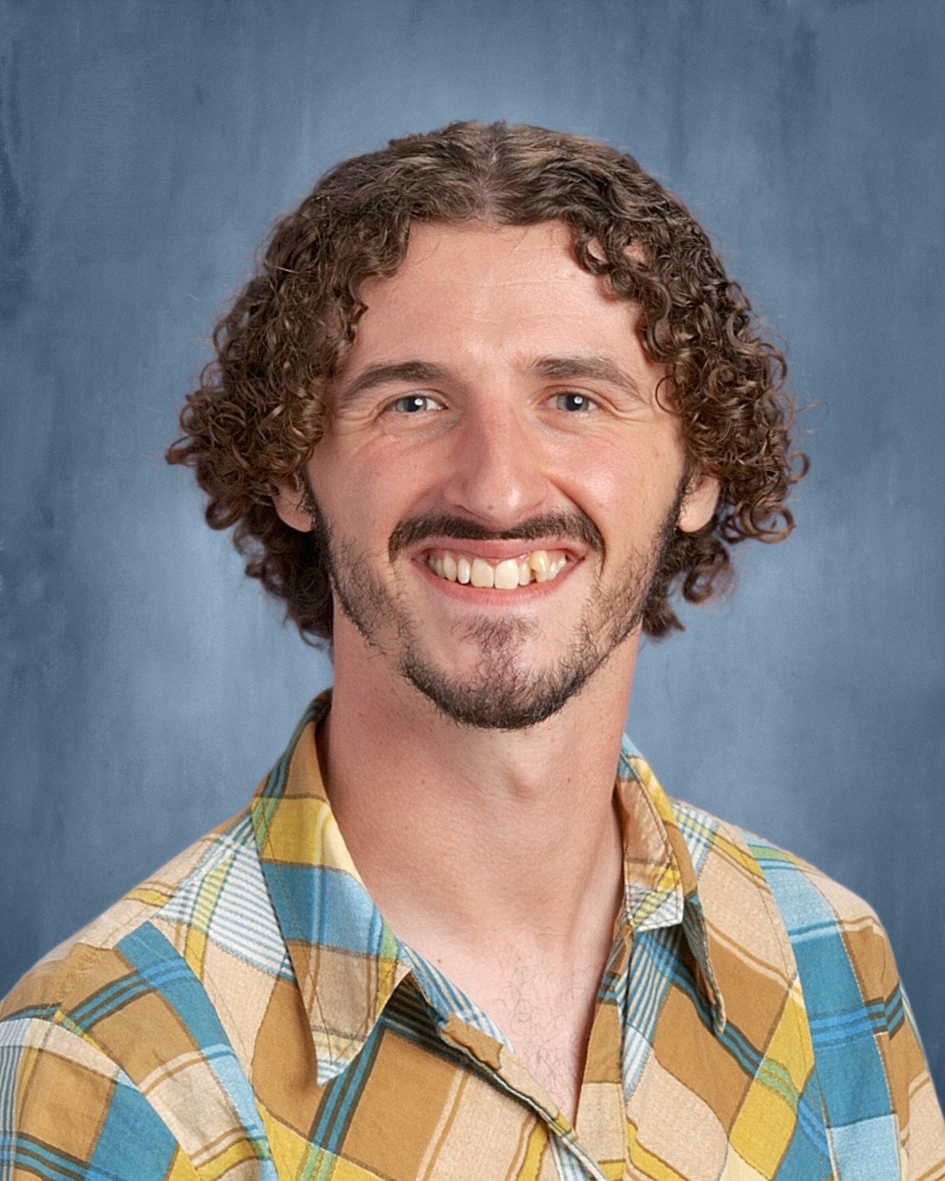 A headshot of Jack Stillman smiling.